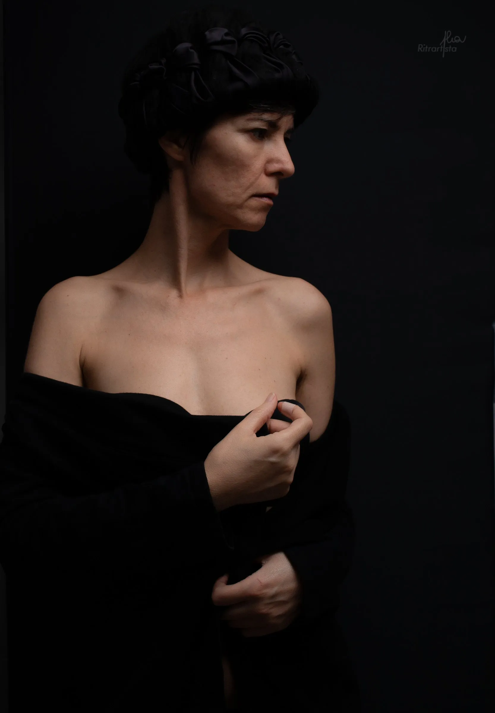 Donna in bianco e nero con lo sguardo di lato, spalle nude
